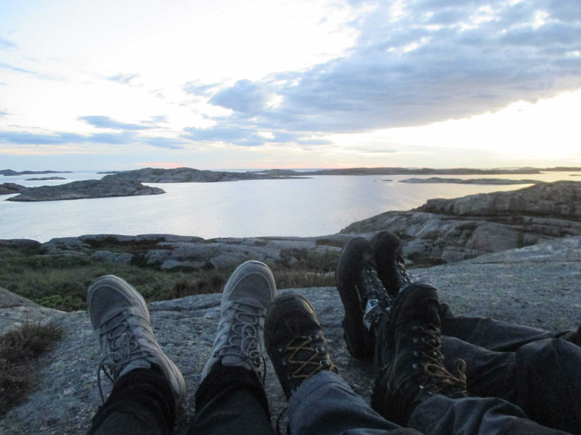 Fuesse auf Felsen mit Blick aufs Wasser